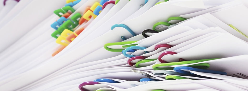 Stack of papers held together by colored paper clips